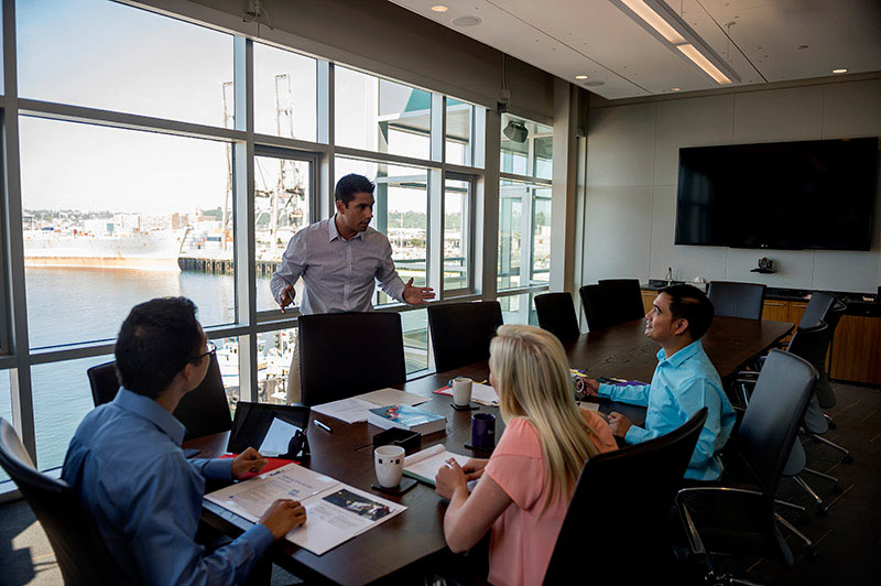 a group of business people talking around table