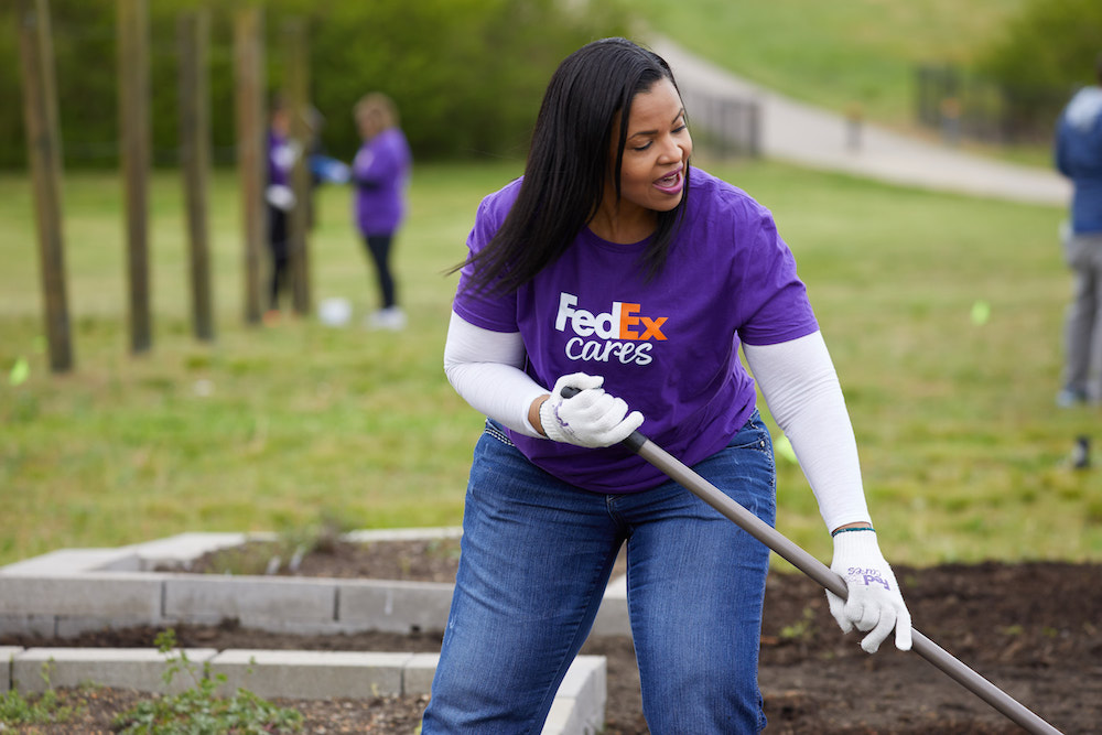 FedEx Cares volunteer helping with garden