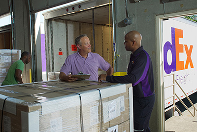 Freight driver and customer with clipboard