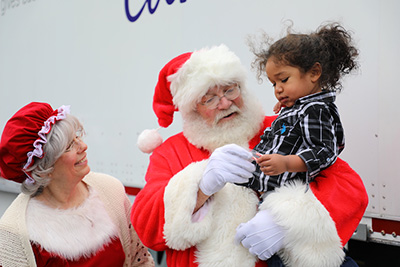 Mr. and Mr.s Claus with child