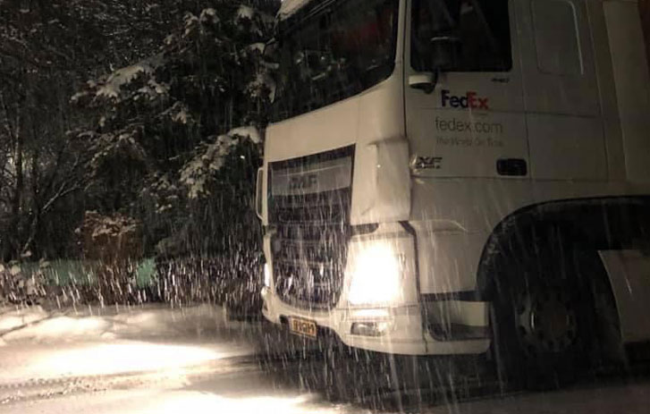 FedEx truck driving in the snow