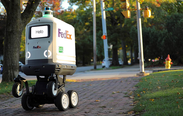 Roxo, the FedEx SameDay Bot, on a cobblestone path.