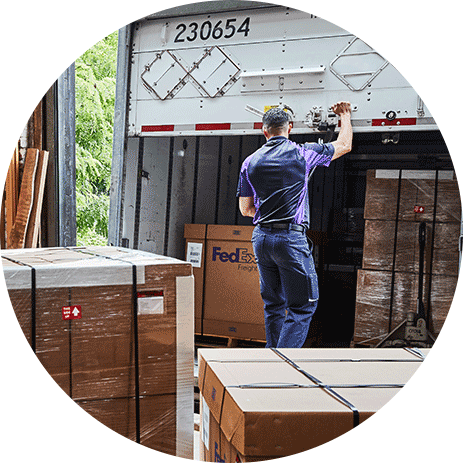 FedEx driver closing the trailer to the freight truck on a docking bay