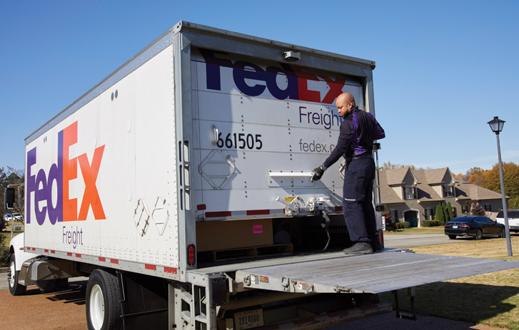 FedEx Freight driver using liftgate to make Freight Direct delivery