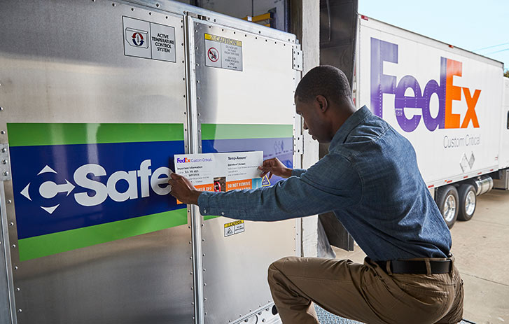 Warehouse employee adding custom critical shipping label to shipment