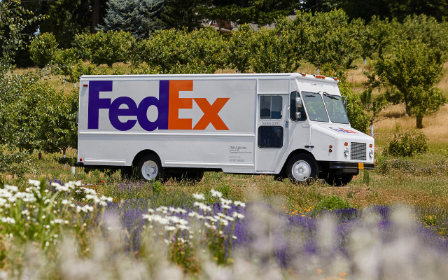 A FedEx truck driving on the road.