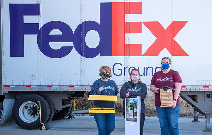 JCs Wildlife employee's standing in front of a FedEx truck