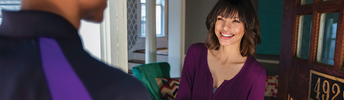 smiling woman opening front door