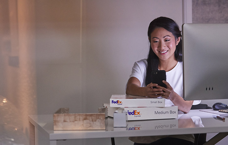 man tracking fedex package on mobile phone