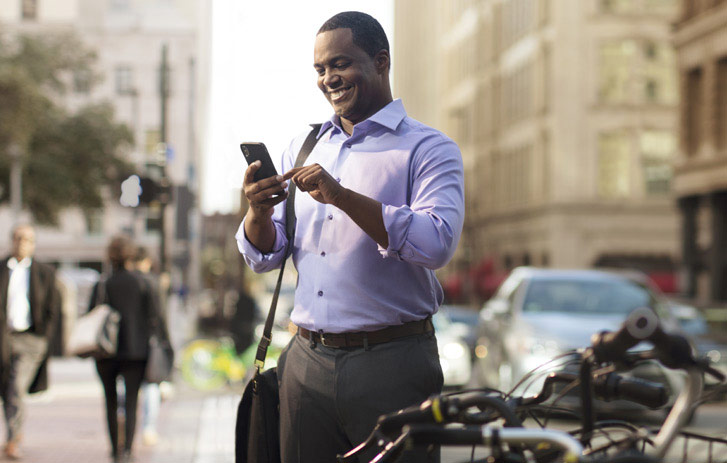 man using smart phone on the street