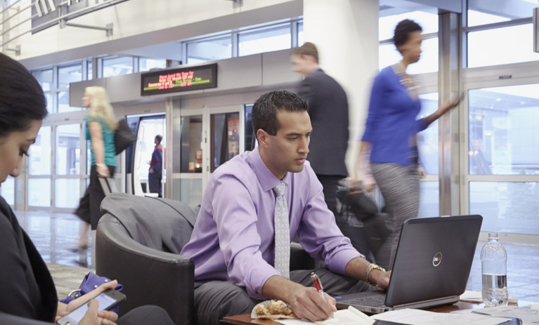 man on laptop in airport
