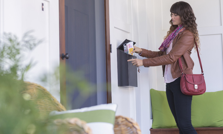 woman checking her mail at home
