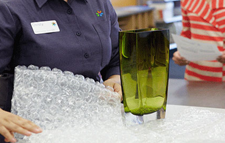 FedEx employee bubble wrapping item