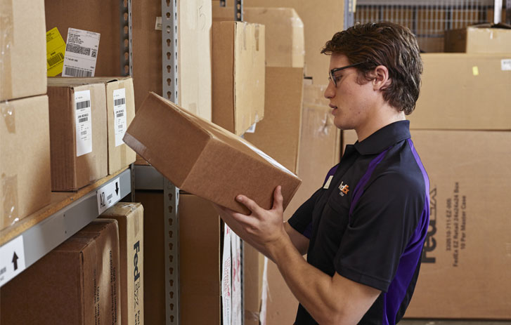 hospitality fedex employee managing package storage room