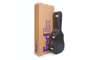 Image of guitar box with guitar case in front.