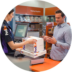 FedEx Office employee and customer with FedEx boxes