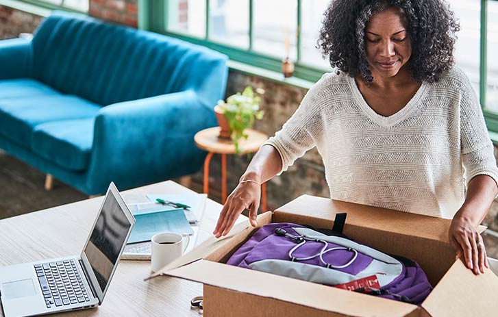 woman returning item in a brown box