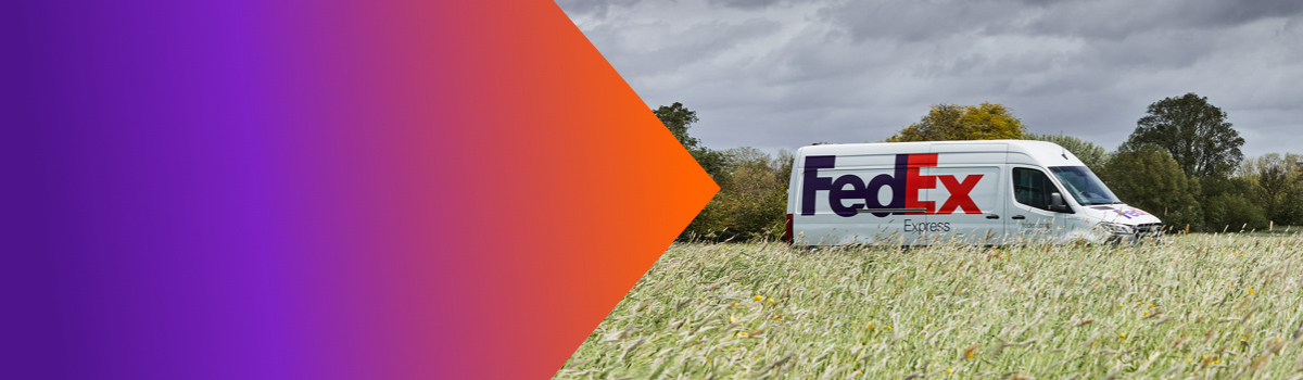 A FedEx van driving through the countryside.