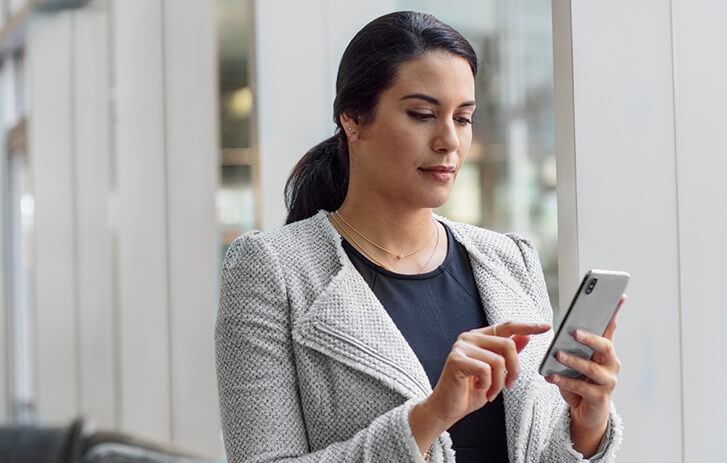 Customer using mobile phone to redirect packages