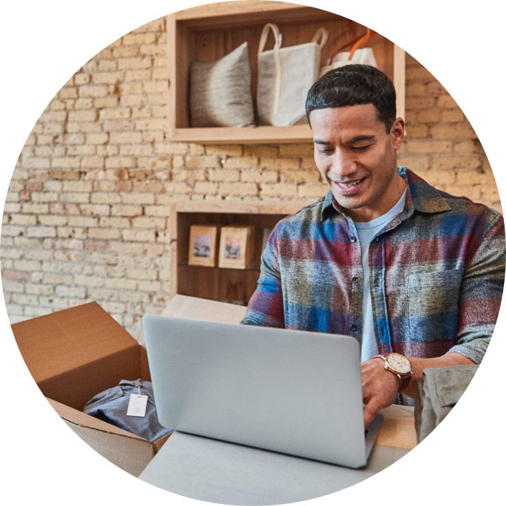 man smiling while working on laptop