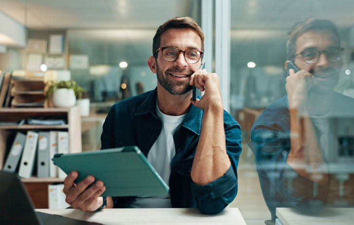 Man looking at shipment orders on laptop