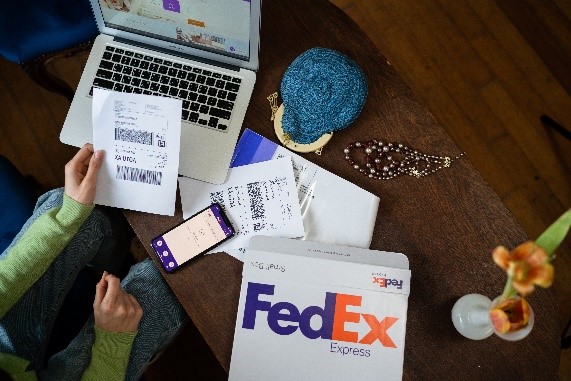 Woman holding addressed FedEx label