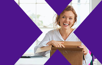 woman smiling while holding FedEx package