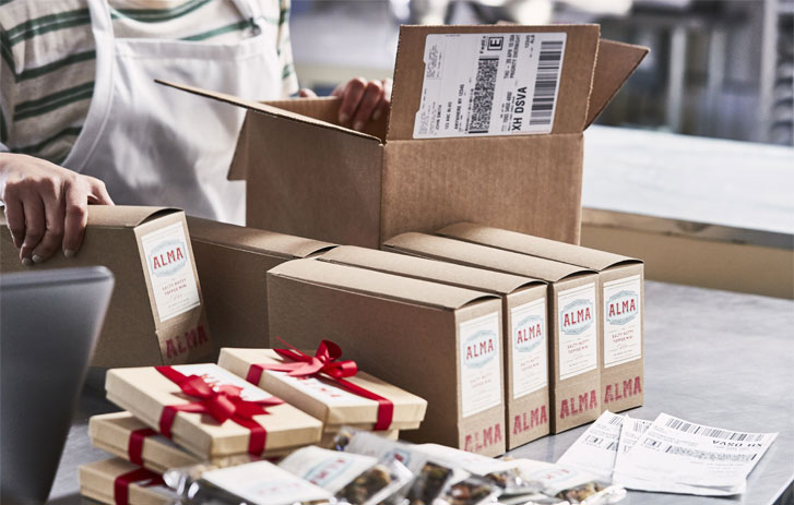 Group of products being placed in box for shipment