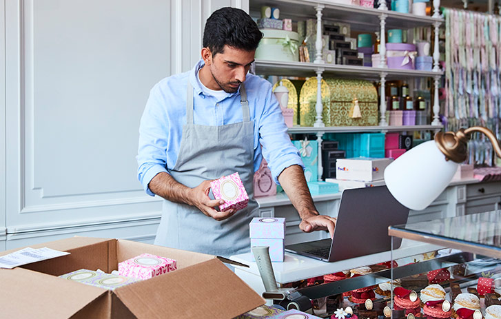 Retail employee boxing items for shipment