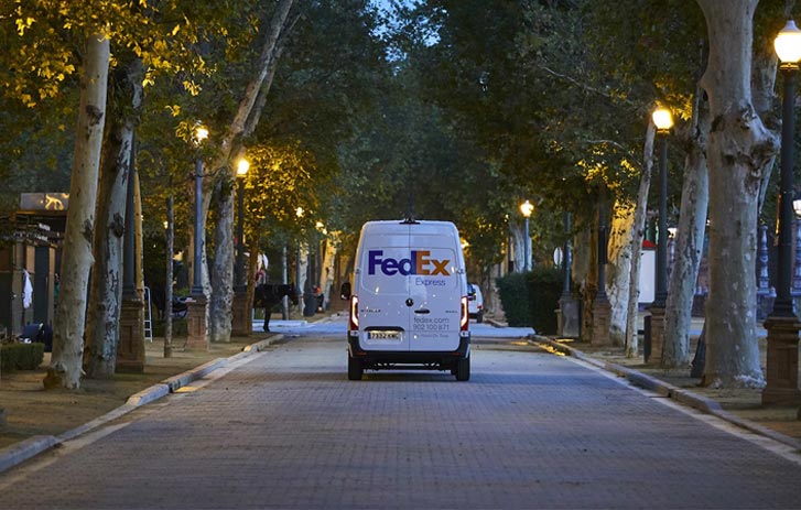 FedEx Express van driving down road
