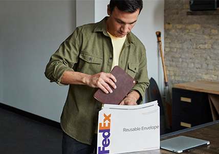 man using reusable fedex packaging