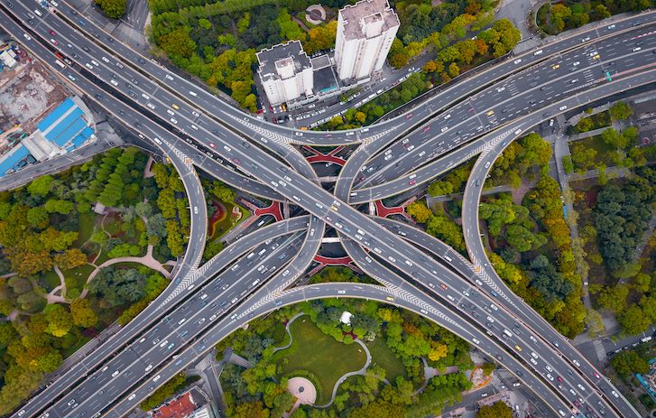 Aerial view of highway junctions shape letter x cross at noon.